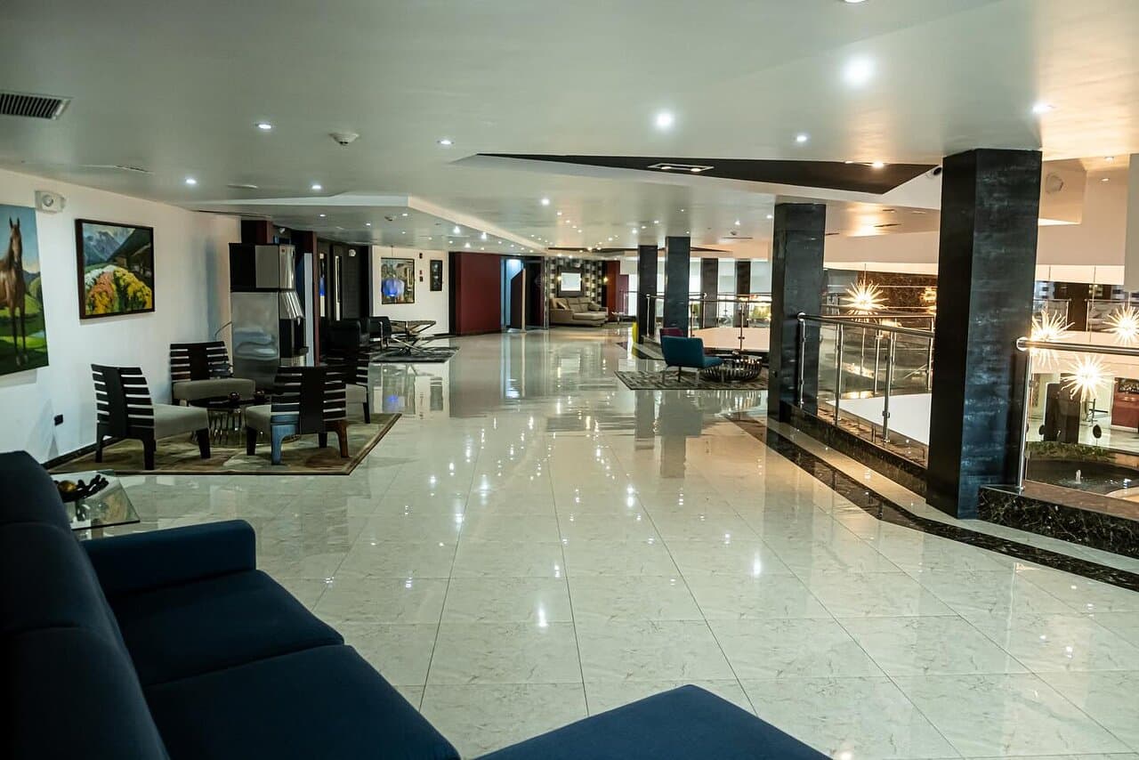 A panoramic view of Punto Fijo's coastline with fishing boats on the calm Caribbean Sea and the city's low-rise buildings in the background