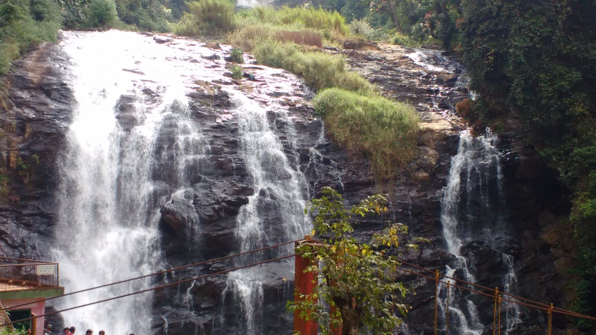 Sri Kothandaramaswamy Temple gopuram against blue sky with devotees in traditional dress entering